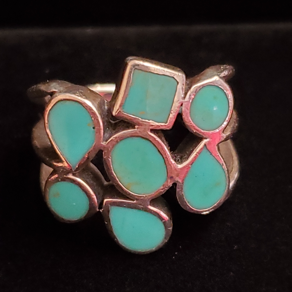 Silver turquoise colored settings ring